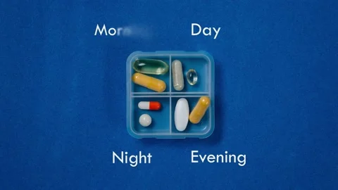 Filling the dispenser with tablets and vitamins for the whole day Stock Footage 158775216