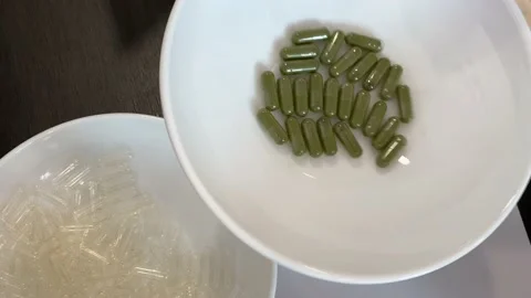 Filling the empty capsules in the capsulizer PART 6. Stock Footage 201308629