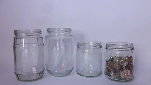 Filling the empty glass jars Stock Footage