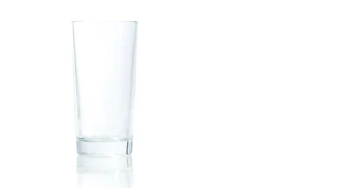 Filling up empty glass with orange juice Stock Footage 65500959
