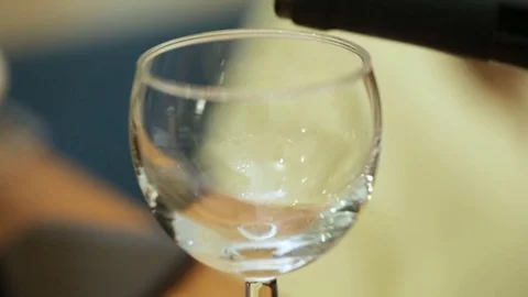 Filling empty glass with red wine Video stock 82543255