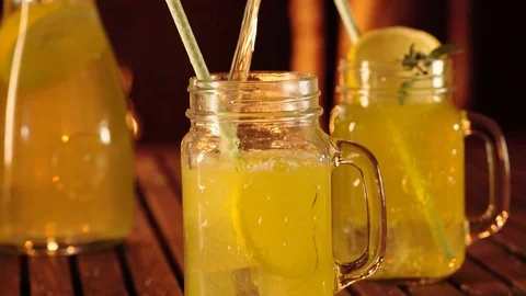 Filling fresh lemonade in mason jar glass Stock Footage 93634361