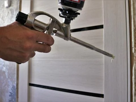 Filling the gap with a construction gun Stock Photos