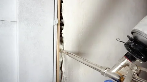 Filling the gap with mounting foam. Stock Footage 273358545