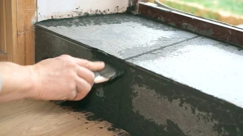 Filling gaps between tiles with grout Stock Footage 75061140