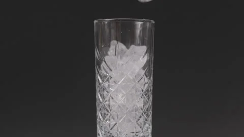 Filling Glas with Ice cubes, Black Background, Clog3, Cinema Gamut Stock Footage 241814844