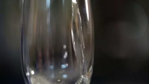 Filling up a glass with champagne close up with bubbles Stock Footage 71783206