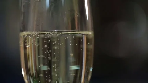 Filling up a glass with champagne close up with bubbles Stock Footage 71783270