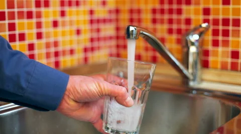 Filling up a glass with drinking water from kitchen tap Stock Footage 57853373