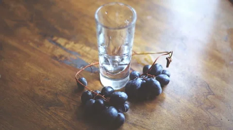Filling a glass of wine on the table, with  grape contour, for a pleasant break Stock-Footage 55628891
