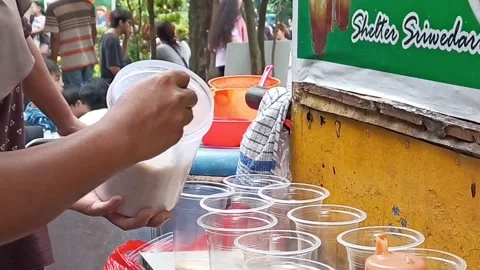 Filling granulated sugar in plastic cups for making iced tea Stock Footage 296520667