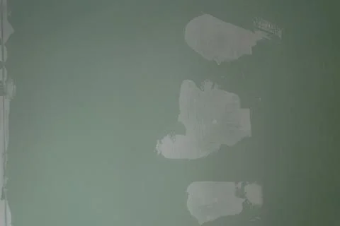 Filling holes with putty on drywall Stock Photos