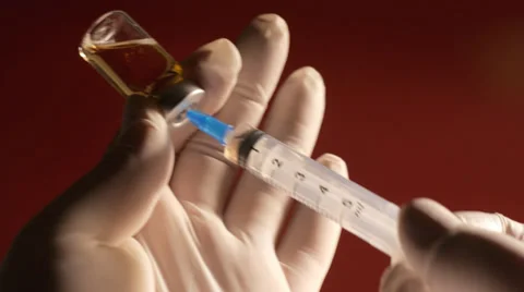 Filling injection syringe from vial Stock Footage 35133964