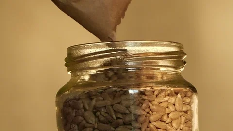 Filling jar with sunflower seed Stock-Footage 72841891