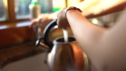 Filling a kettle Stock Footage 199220041