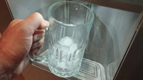 Filling large mug with ice from a fridge ice dispenser Stock Footage 310683432