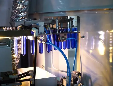 Filling line in plastic flasks. Liquid Filling Stock Photos
