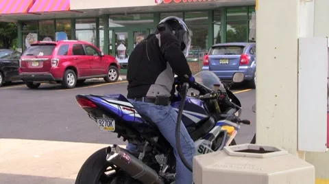 Filling a motorcycle tank Stock Footage 8601720