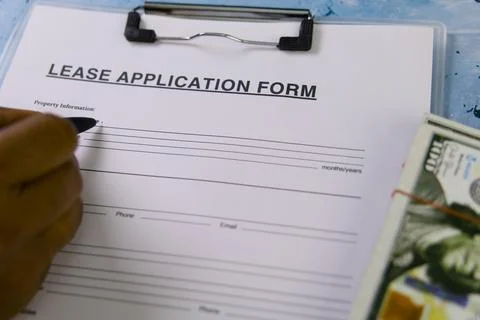 Filling out a lease application form for rental property Stock Photos
