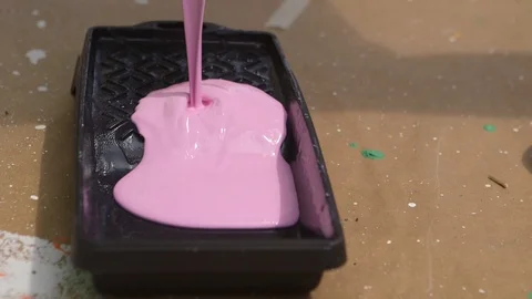 Filling Up A Paint Tray With Pink Paint From A Bucket Stock Footage 126700853