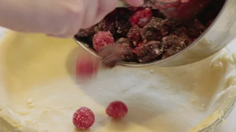 Filling a pie with sugared cherries 4K Stock Footage 48207808