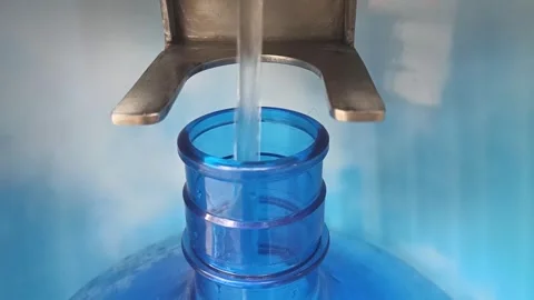 Filling a plastic bottle with drinking water from a machine Stock Footage 277342818