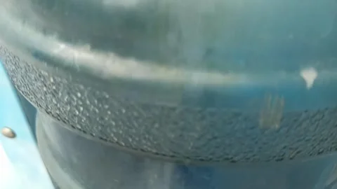 Filling a plastic bottle with drinking water from a machine Stock Footage 277495985