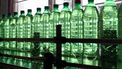 Filling Plastic Bottles Production Line Moves along the Conveyor belt Closeup Stock Footage 334587393