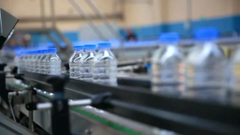 Filling Plastic Bottles Production Line Moves along the Conveyor belt Closeup Stock Footage 334587412