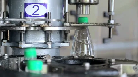 Filling Plastic Bottles Production Line Moves along the Conveyor belt Closeup Stock-Footage 334588944
