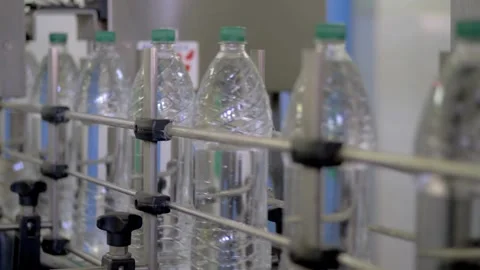 Filling Plastic Bottles Production Line Moves along the Conveyor belt Closeup Stock-Footage 334589048