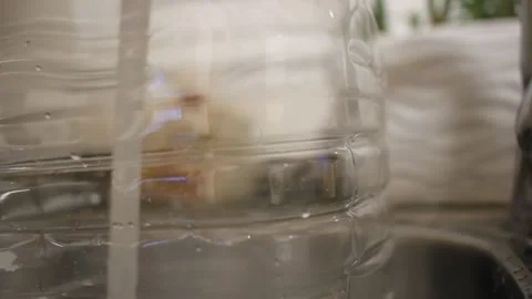 Filling a plastic canister with water Stock Footage 330774430