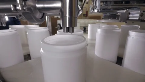Filling of plastic containers at a factory. Stock Footage 77871331