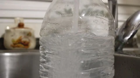 Filling a plastic jug with water Stock Footage 330774431