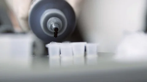 Filling plastic pots with tattoo ink - Tattooing preparation. Stock Footage 83277355