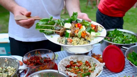 Filling plates at community dinner or potluck Stock Footage 92394998