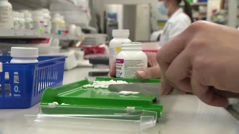 Filling prescriptions for customers at a pharmacy in Toronto, Canada Stock Footage