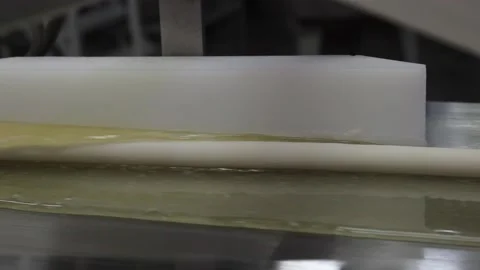The filling for the production of caramel sweets gets into the hot caramel Stock Footage 130395043