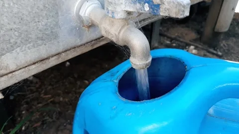 Filling a  rainwater water can Stock Footage 153342773