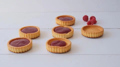Filling raspberry tartlets with cream. Party preparation Stock Footage 242918187