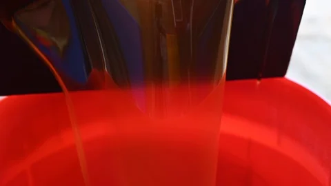 Filling a red bin with used waste oil from a deep fryer Stock Footage 119393910