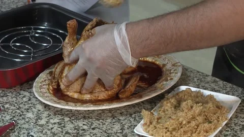 Filling rice inside the chicken and cooking Stock Footage 146897965