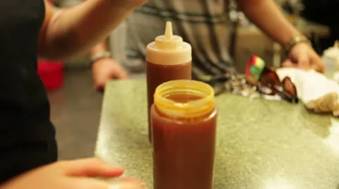 Filling sauce bottles at grill, close-up, handheld Stock Footage 25912683