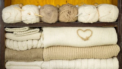 Filling shelves by balls of wool, knitting needles, woollen fabrics, decorations Stock Footage 85386973