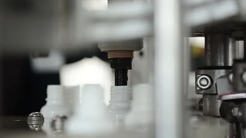 Filling in small bottles with a liquid product Stock Footage 94972639