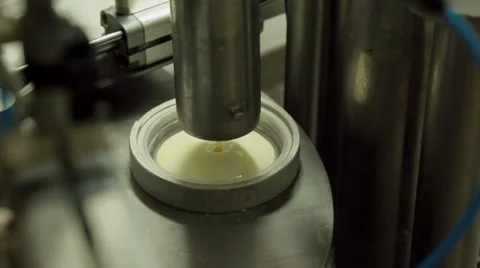 Filling small cups with fruit yogurt Stock Footage 36193753