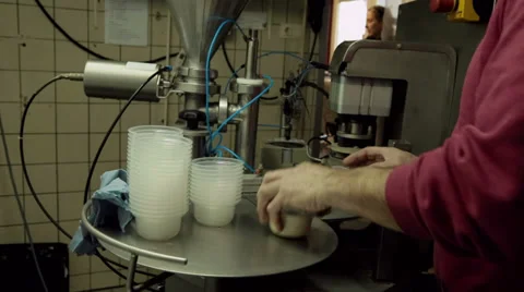 Filling small cups with fruit yogurt Stock Footage 36193953