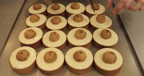 Filling small eclairs with cream using a culinary syringe Stock Footage 254812958