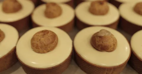 Filling small eclairs with cream using a culinary syringe Stock Footage 254813375