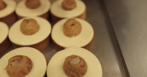 Filling small eclairs with cream using a culinary syringe Stock Footage 254815354